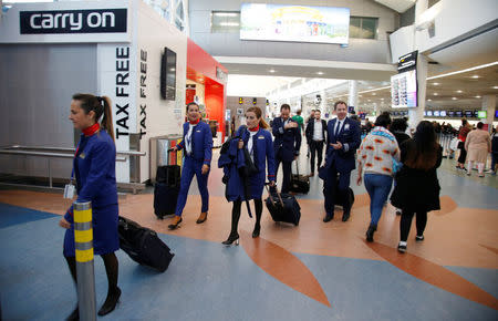 Airline staff walk through Auckland Airport during fuel shortages in New Zealand, September 20, 2017. Picture taken September 20, 2017. REUTERS/Nigel Marple