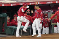 Los Angeles Angels' Shohei Ohtani, left, is congratulated by Jose Iglesias after hitting a three-run home run during the fourth inning of a baseball game against the Texas Rangers Tuesday, May 25, 2021, in Anaheim, Calif. (AP Photo/Mark J. Terrill)