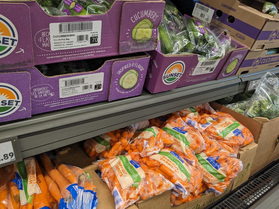 Bagged cucumbers and carrots in produce section of Aldi