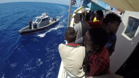 Migrants are seen on the ship Lifeline while the Malta Armed Forces arrive to send aid, near Malta in International Waters June 23, 2018 in this still image taken from a video obtained from social media. MISSION LIFELINE/via REUTERS