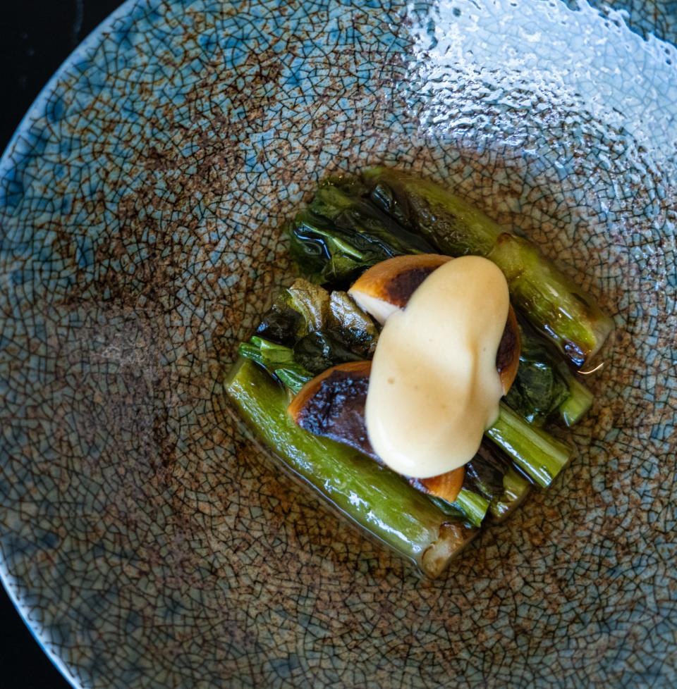 A dish of gai lan nods to chef-owner Charlie Wang's Chinese heritage.