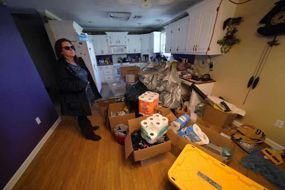 Provisions are piled on the floor of Dewana Young's heavily damaged home, in the aftermath of both Hurricane Laura and Hurricane Delta, in Grand Lake, La., Friday, Dec. 4, 2020. (AP Photo/Gerald Herbert)