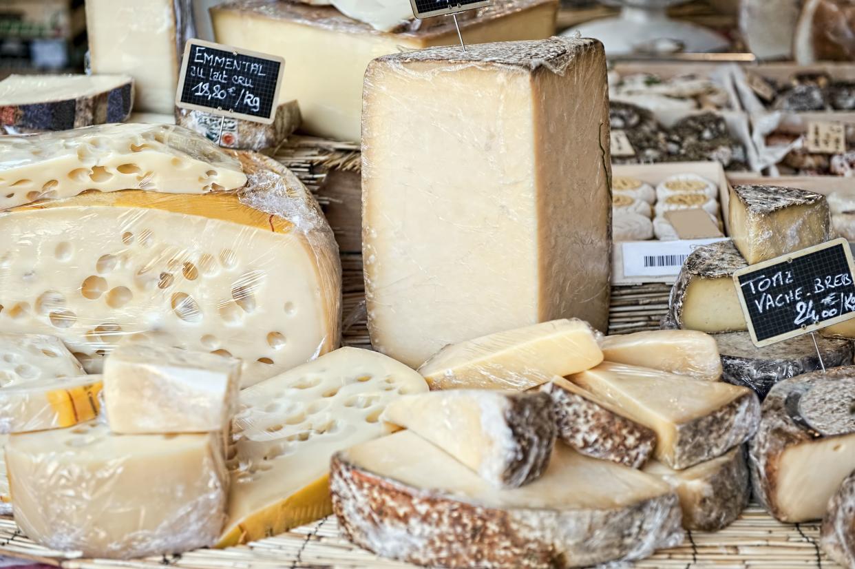 Variation of french cheese in market stall in Aix en Provence (France).