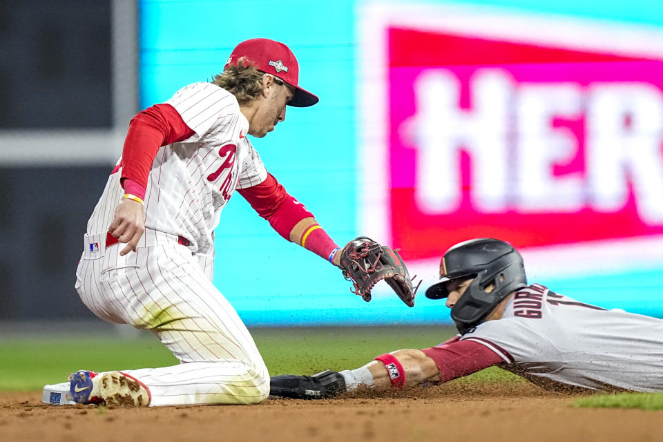 Arizona Diamondbacks' Lourdes Gurriel Jr. steals second past Philadelphia Phillies second baseman Bryson Stott during the second inning in Game 7 of the baseball NL Championship Series in Philadelphia Tuesday, Oct. 24, 2023. (AP Photo/Brynn Anderson)