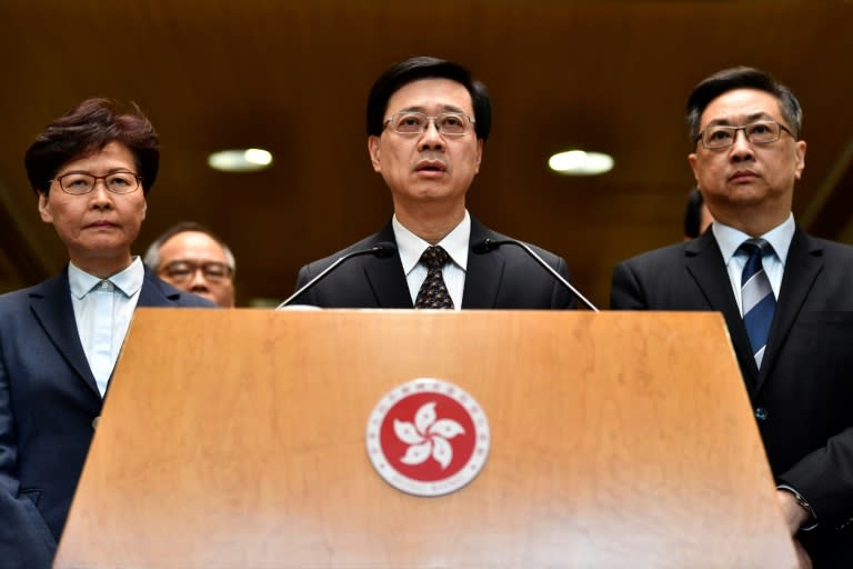 Insiders say the unwavering commitment of John Lee (C) to the suppression of pro-democracy protests won China's confidence at a time when other Hong Kong elite were seen as insufficiently loyal or competent (AFP/Anthony WALLACE)