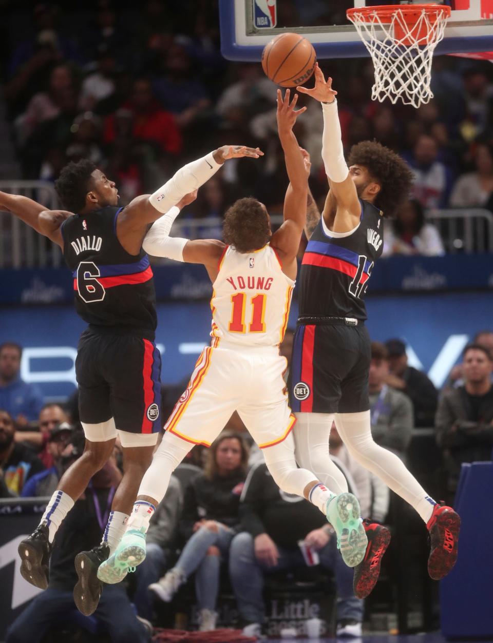 Detroit Pistons forward Isaiah Livers (12) blocks a shot by Atlanta Hawks guard Trae Young (11) during first-quarter action on Wednesday, Oct. 26, 2022, at Little Caesars Arena in Detroit.