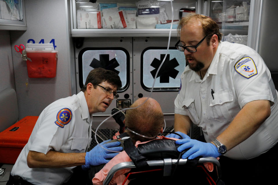 Cataldo Ambulance medics John Gardner (L) and David Farmer care for a man in his 40's who was found unresponsive after overdosing on an opioid in the Boston suburb of Salem, Massachusetts, U.S., August 9, 2017.  The victim received a total of 12mg of naloxone. Nurses at the hospital recognised the man, saying he was brought in the day before after overdosing. REUTERS/Brian Snyder  SEARCH "SNYDER OPIOIDS" FOR THIS STORY. SEARCH "WIDER IMAGE" FOR ALL STORIES.