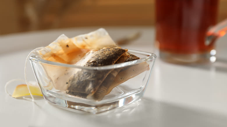 Glass bowl with used tea bags 