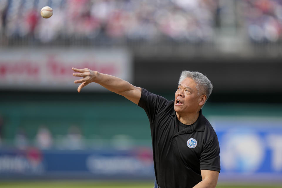 Deputy Secretary of Homeland Security John Tien throws out a ceremonial first pitch before a baseball game between the Washington Nationals and the Atlanta Braves at Nationals Park, Saturday, April 1, 2023, in Washington. (AP Photo/Alex Brandon)