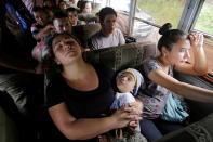 <p>A woman sleeps with her baby as they travelon a bus with fellow Hondurans fleeing poverty and violence in a caravan toward the United States, in western Honduras, Oct. 14, 2018. (Photo: Jorge Cabrera/Reuters) </p>