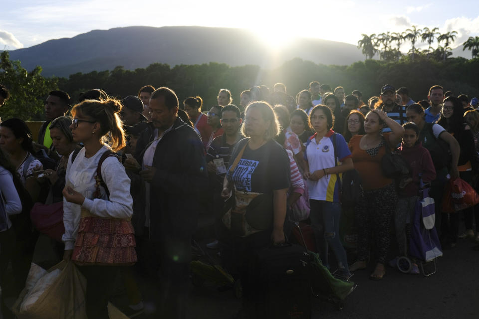 Venezuelans line up to cross the Simon Bolivar international bridge into Cucuta, Colombia, Saturday, June 8, 2019. Venezuela's President Nicolas Maduro ordered the partial re-opening of the border that has been closed since February when he stationed containers on the bridge to block an opposition plan to deliver humanitarian aid into the country. (AP Photo/Ferley Ospina)