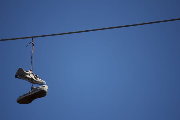 Sneakers hanging from telephone wire