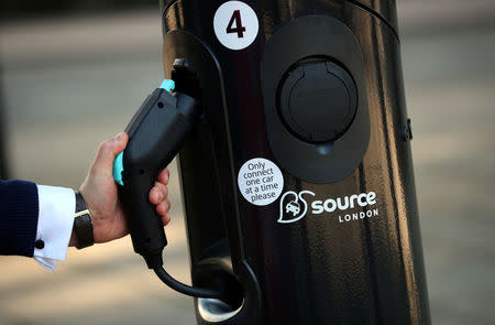 A man uses an electric car charging point in London, Britain September 1, 2017. REUTERS/Hannah McKay