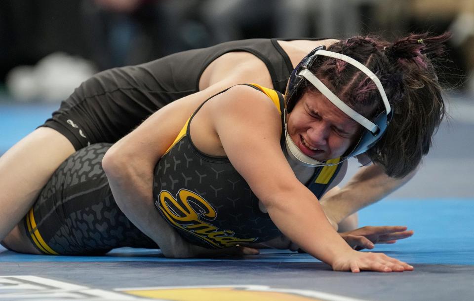 Bloomington South's Cameron Meier (top) and Fort Wayne Snider's Julianna Ocampo wrestle in a 106-pound match Friday, Feb. 17, 2023, during IHSAA wrestling state final preliminaries at Gainbridge Fieldhouse in Indianapolis.