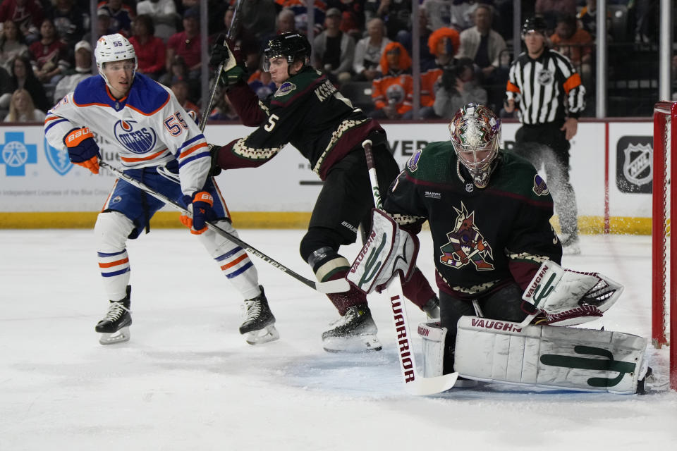 Arizona Coyotes goalie Matt Villalta makes the save in front of Edmonton Oilers left wing Dylan Holloway (55) in the first period during an NHL hockey game, Monday, Feb. 19, 2024, in Tempe, Ariz. (AP Photo/Rick Scuteri)