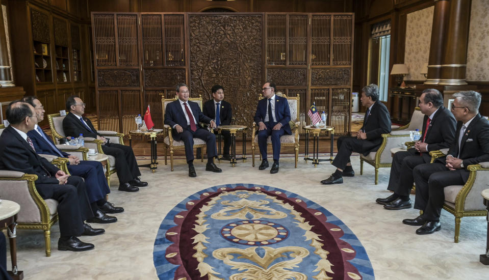 In this photo released by Malaysia's Department of Information, China's Premier Li Qiang, center left, meets with Malaysia Prime Minister Anwar Ibrahim, center right, in Putrajaya, Malaysia, Wednesday, June 19, 2024. (Malaysia's Department of Information via AP)