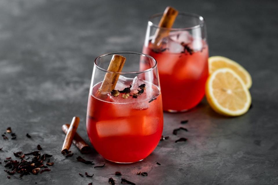 Herbal mocktail with cinnamon, lemon and edible flowers.