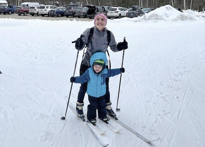 In this photo provided by Nancy Mazonson, Leah Ofsevit, of Melrose, Mass., top, and her 3-year-old son Lewis Garczynski pose for a photo while skiing at Waterville Valley Resort, in Waterville Valley, N.H., in January 2023. The family drove two hours from their home to the New Hampshire resort since there has been almost no snow in the Boston area. (Nancy Mazonson via AP)
