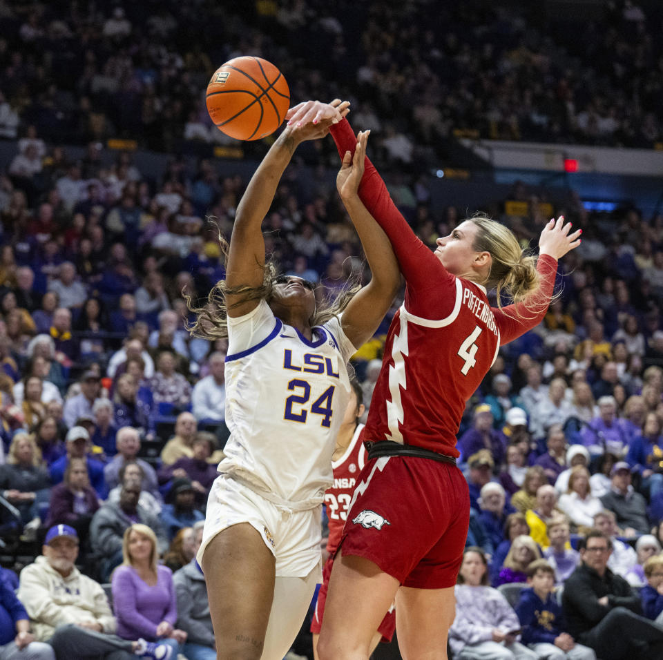 LSU guard Aneesah Morrow (24) is fouled by Arkansas guard Saylor Poffenbarger (4) in the second period of an NCAA college basketball game Sunday, Jan. 21, 2024, in Baton Rouge, La. (Michael Johnson/The Advocate via AP)