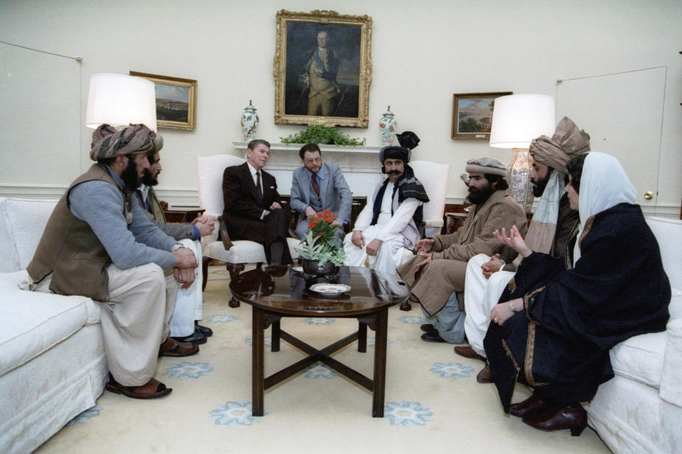 FILE - In this photo courtesy Ronald Reagan Library, then President Ronald Reagan meets with Afghan "freedom fighters" on Feb. 2, 1983, in the Oval Office of the White House in Washington, to discuss Soviet atrocities in Afghanistan. The former Soviet Union marched into Afghanistan on Christmas Eve, 1979, claiming it was invited by the new Afghan communist leader, Babrak Karmal, setting the country on a path of 40 years of seemingly endless wars and conflict. After the Soviets left in humiliation, America was the next great power to wade in. (Courtesy Ronald Reagan Library via AP)