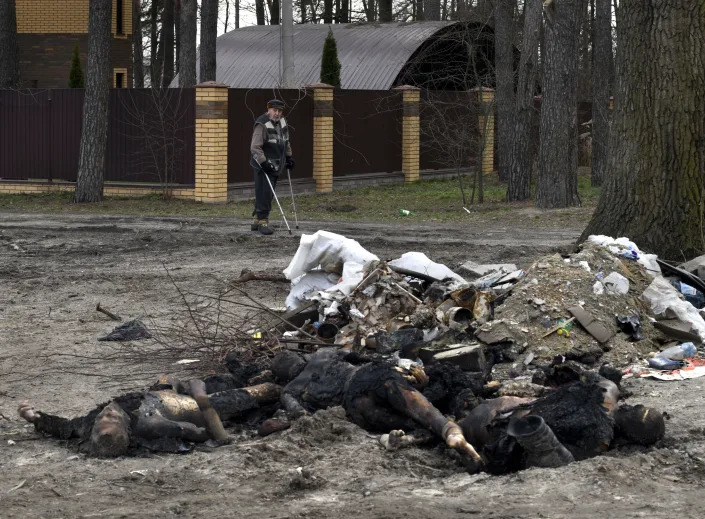 Charred bodies, including those of women and children, lie in a pile in Bucha on April 3.