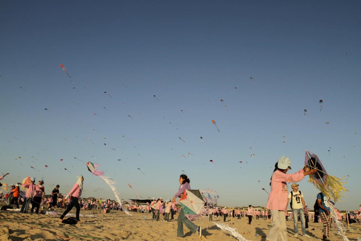 PHOTO: Palestinian children attend a kite festival organized by the United Nations Relief and Works Agency in which they attempt to break the Guinness world record for the largest number of kites flown simultaneously, July 28, 2011. (Mohammed Abed/AFP via Getty Images)