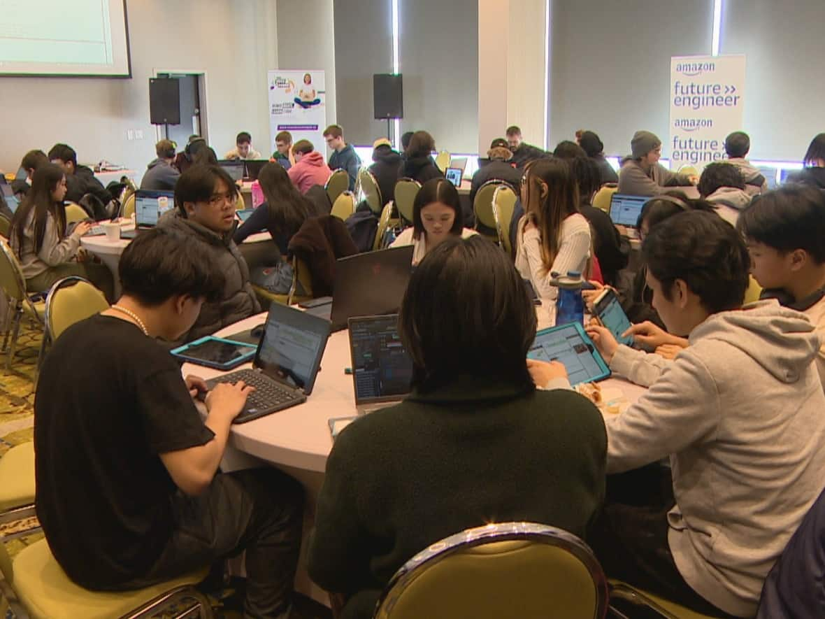 Around 100 Saskatoon high school students participated in the 'Your Voice is Power' Hackathon. They learned to remix music from Indigenous Artists using coding.  (Travis Reddaway/CBC - image credit)