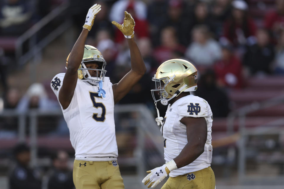 Notre Dame running back Audric Estime, right, is congratulated by wide receiver Tobias Merriweather (5) after scoring a touchdown against Stanford during the first half of an NCAA college football game in Stanford, Calif., Saturday, Nov. 25, 2023. (AP Photo/Jed Jacobsohn)