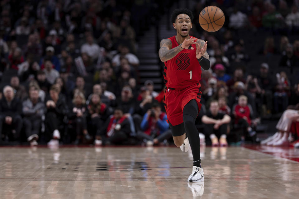 Portland Trail Blazers guard Anfernee Simons passes the ball against the Detroit Pistons during the first half of an NBA basketball game Thursday, Feb. 8, 2024, in Portland, Ore. (AP Photo/Howard Lao)