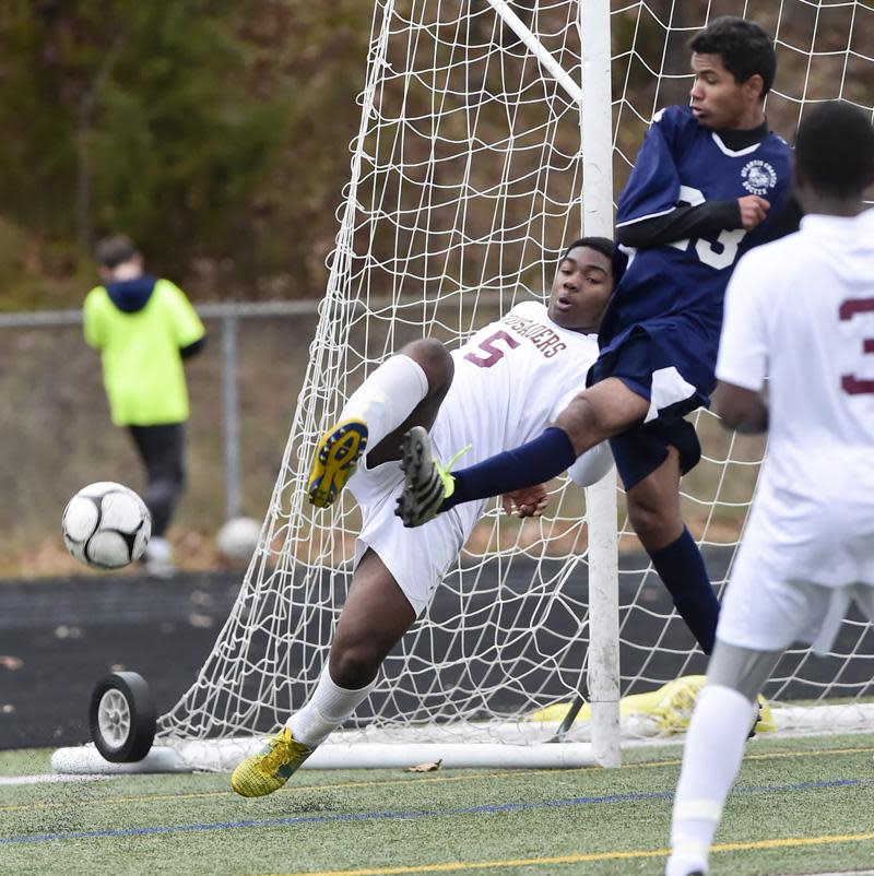 Atlantis Charter André Coelho-Filho, middle, battles a defender near the goal in 2019 game against Cape Cod Tech.