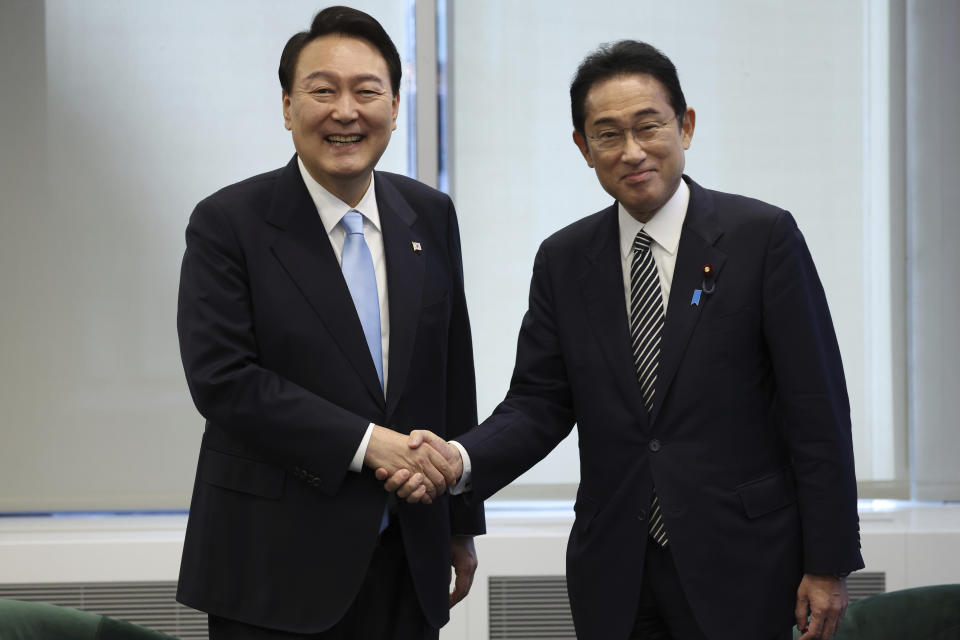 South Korean President Yoon Suk Yeol, left, shakes hands with Japanese Prime Minister Fumio Kishida before their meeting in New York, Wednesday, Sept. 21, 2022. Yoon and Kishida agreed to accelerate efforts to mend ties frayed over Japan’s past colonial rule of the Korean Peninsula as they held their countries' first summit talks in nearly three years on the sidelines of the U.N. General Assembly in New York, Seoul officials said Thursday, Sept. 22, 2022. (Ahn Jung-won/Yonhap via AP)
