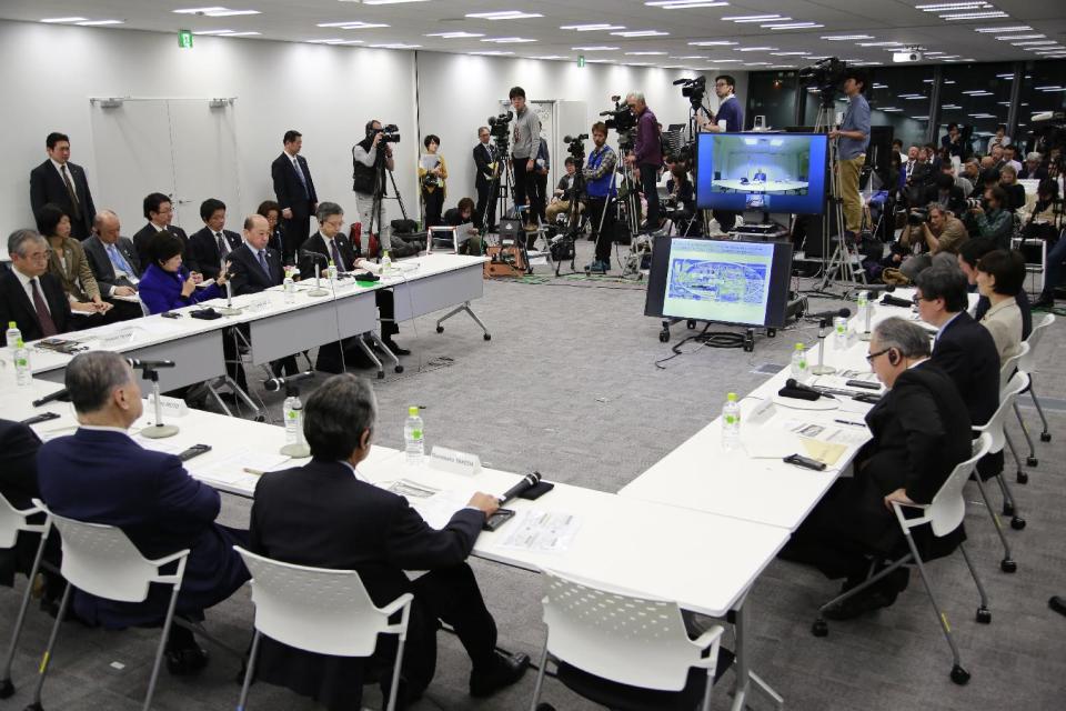 On the left side; Tokyo Gov. Yuriko Koike, center, speaks with Tokyo Olympics Organizing Committee President Yoshiro Mori, left, at the Four-Party Working Group meeting in Tokyo, Wednesday, Dec. 21, 2016. Japanese Olympic organizers presented their first official cost estimate for the 2020 Tokyo Games at a level slightly below their promised 2 trillion ($17 billion) cap. (AP Photo/Shizuo Kambayashi)