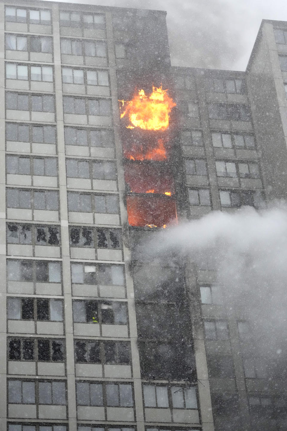 Flames leap skyward out of the Harper Square cooperative residential building in the Kenwood neighborhood of Chicago, Wednesday, Jan. 25, 2023. (AP Photo/Charles Rex Arbogast)