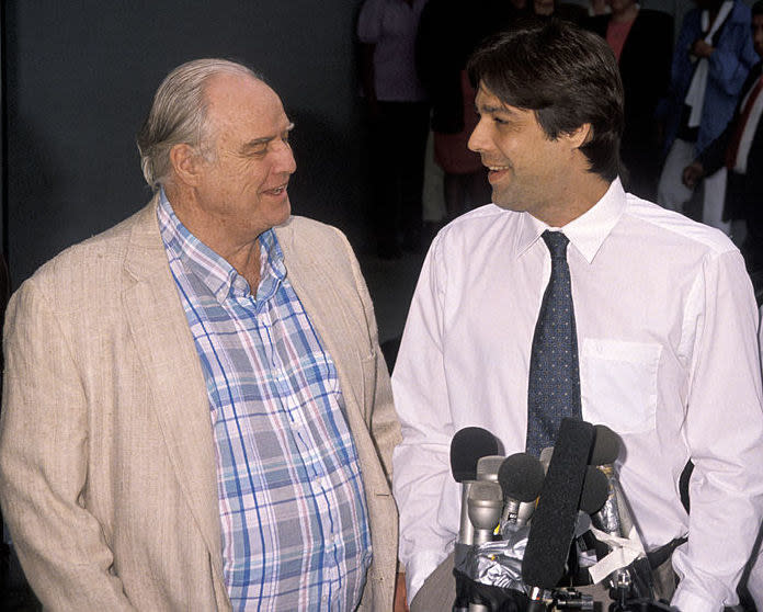 Marlon Brando and Christian Brando speak at a news conference after Christian was released on $2 million bail in Los Angeles on Aug. 15, 1990. 