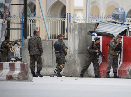 Afghan security forces take position at the site of a suicide car bomb attack in Kabul, Afghanistan April 19, 2016. REUTERS/Omar Sobhani