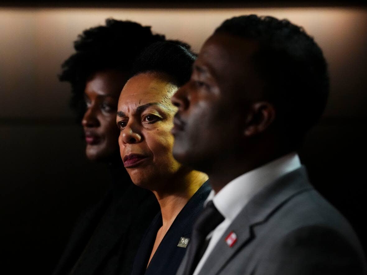 Left to right, Ketty Nivyabandi, secretary general of Amnesty International Canada, Norma Domey, national vice-president of the Professional Institute of Public Service of Canada, and Nicolas Marcus Thompson, executive director of the Black Class Action Secretariat, hold a news conference on Parliament Hill in Ottawa on Sept. 28, 2022. (Sean Kilpatrick/The Canadian Press - image credit)