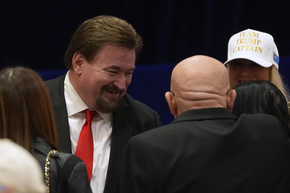 FILE - Nevada Republican Party chairman Michael McDonald talks to guests at a caucus night rally in Las Vegas, Feb. 8, 2024. Six Republicans accused of falsely declaring Donald Trump the winner of Nevada’s 2020 presidential election will not stand trial until sometime next year. A Nevada judge on Monday, March 4, 2024 pushed back the trial date due to conflicting schedules. The judge also set an April 22 hearing on a bid by McDonald and other defendants to throw out the indictment. (AP Photo/Mark J. Terrill, file)