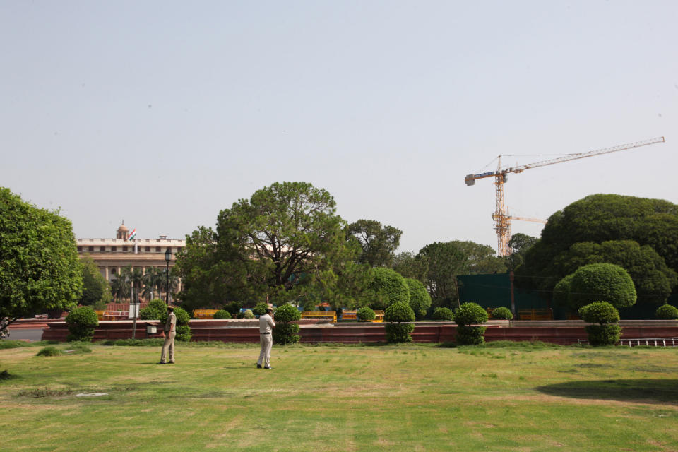 The round heritage building of the Indian Parliament can be seen with massive cranes for the construction of the new Parliament building on June 5, 2021.<span class="copyright">Pallava Bagla—Corbis/Getty Images</span>