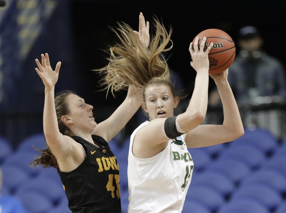 Baylor's Lauren Cox, right, drives against Iowa's Amanda Ollinger, left, during the first half of a regional final women's college basketball game in the NCAA Tournament in Greensboro, N.C., Monday, April 1, 2019. (AP Photo/Chuck Burton)