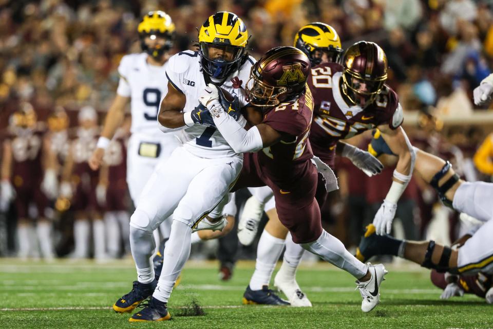 Michigan Wolverines running back Donovan Edwards makes a catch while Minnesota Golden Gophers defensive back Tariq Watson defends during the second quarter at Huntington Bank Stadium in Minneapolis on Saturday, Oct. 7, 2023.