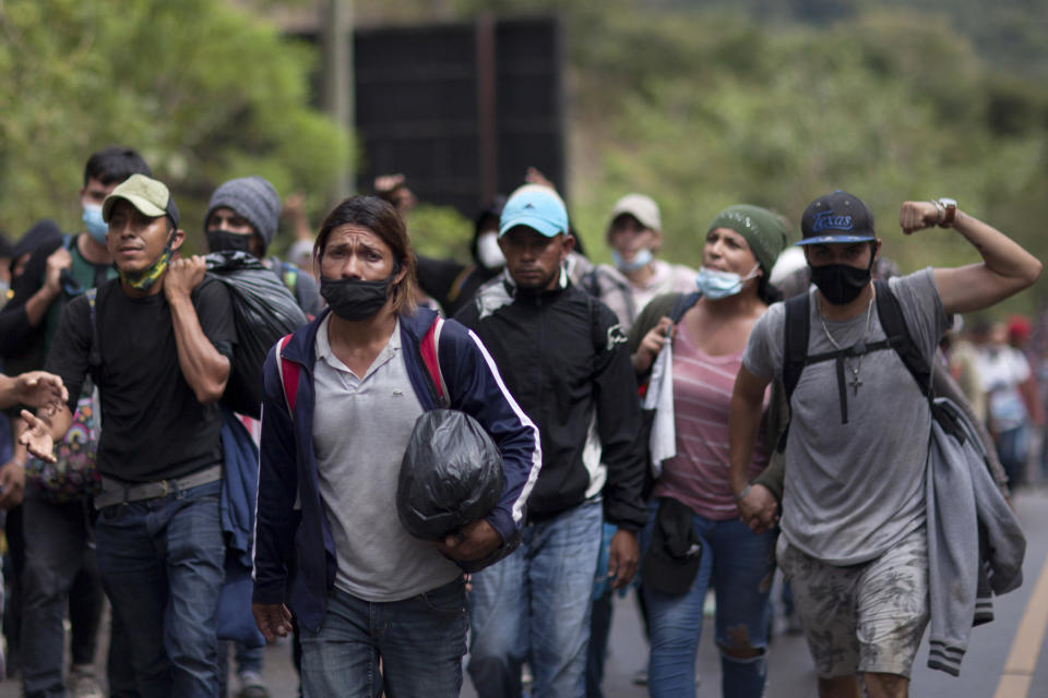 Migrants hoping to reach the U.S. border walk alongside a highway in Chiquimula, Guatemala, Saturday, Jan. 16, 2021. Guatemalan authorities estimated that as many as 9,000 Honduran migrants have crossed into Guatemala as part of an effort to form a new caravan to reach the U.S. border. (AP Photo/Sandra Sebastian)