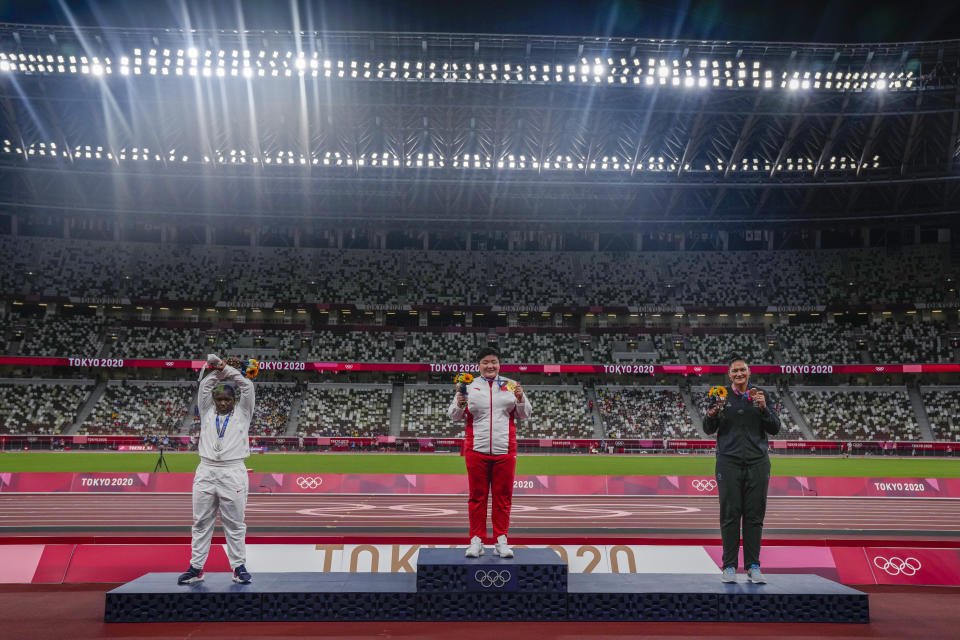 China's Lijia Gong, center, poses with her gold medal after winning women's shot put next to Raven Saunders, of the United States, left, silver medal, and New Zealand's Valerie Adams, bronze medal, at the 2020 Summer Olympics, Sunday, Aug. 1, 2021, in Tokyo, Japan. (AP Photo/Francisco Seco)