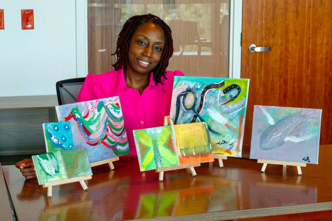 Latoya Simmons, 42, showcases some of the paintings she made while undergoing chemotherapy for breast cancer at the Miami Cancer Institute, part of Baptist Health South Florida.