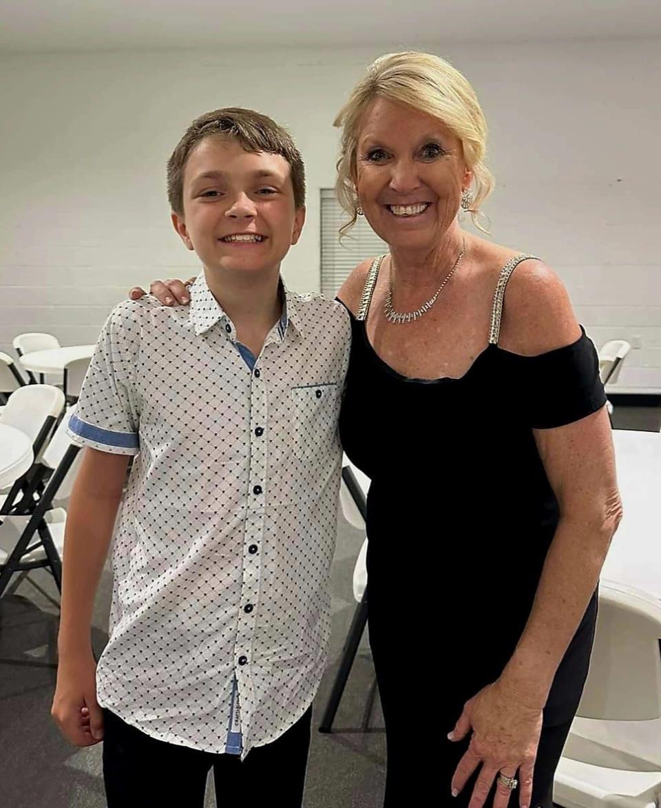 Carter takes a photo with the School of Hope's administrator, Amy Sparks, during the school's prom May 13, 2023.