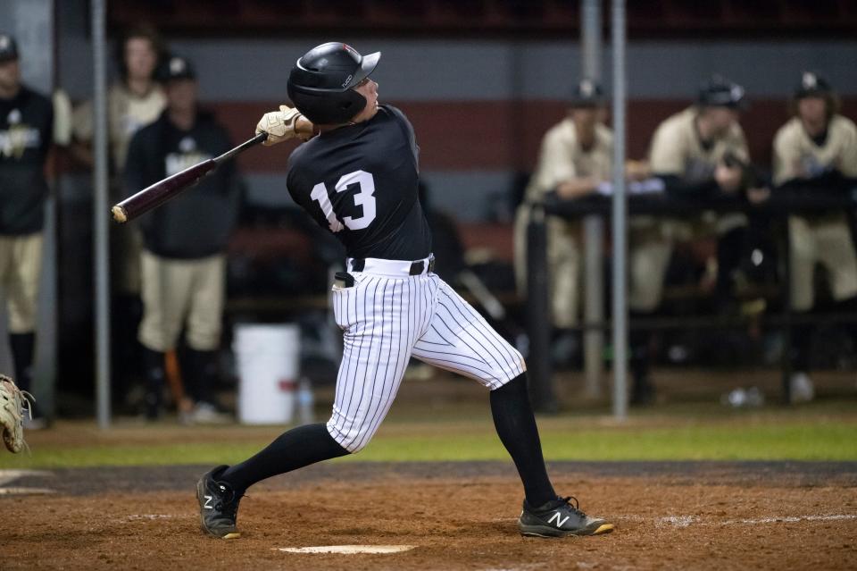 Brayden Touchstone (13) bats during the Tate vs. Broken Arrow baseball game at Tate High School in Cantonment on Thursday, March 17, 2022.