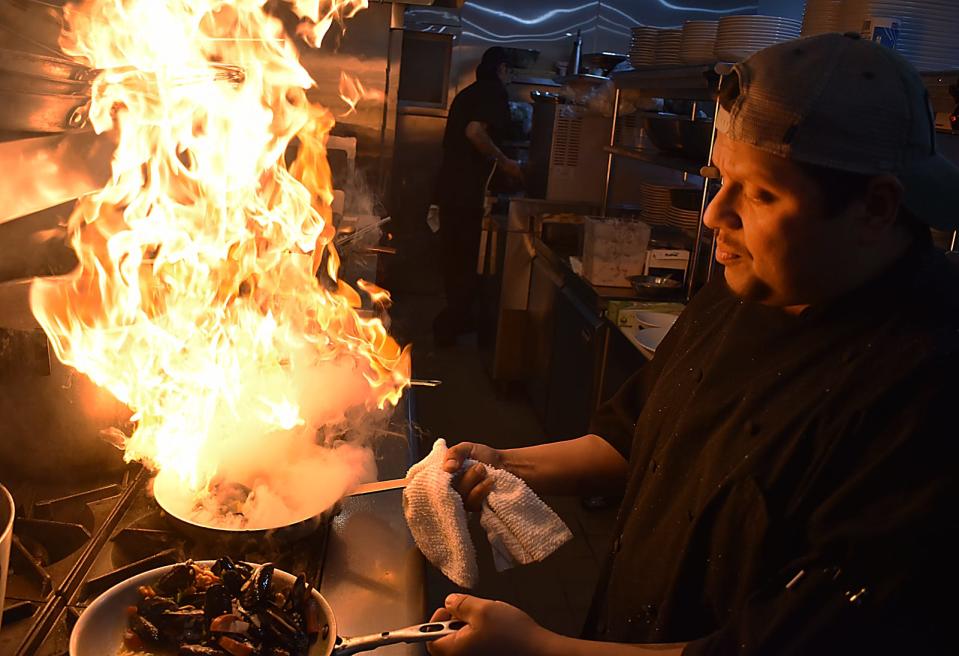 Chef Chris Baccelli whips up a dish at Black Salt's soft opening Thursday, Nov. 17, 2022, in Swansea.