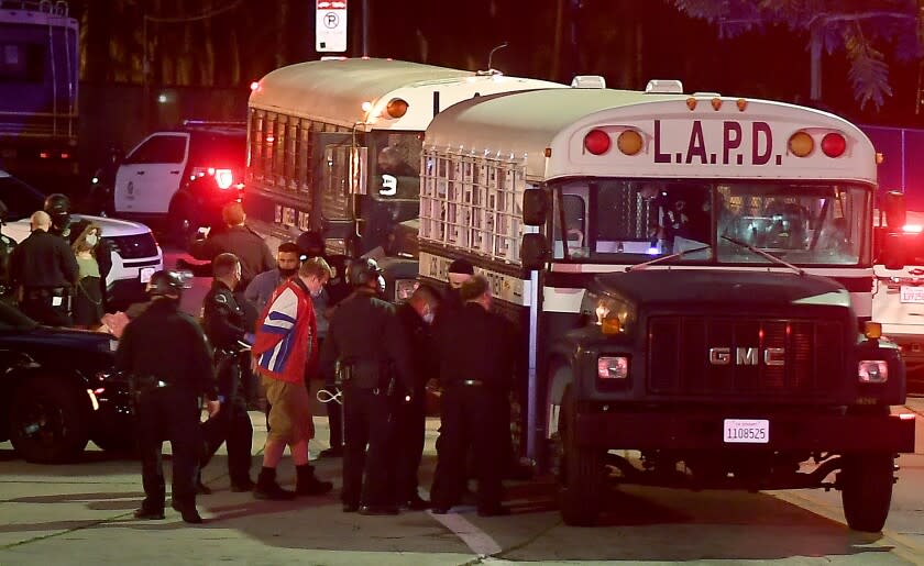 LOS ANGELES CALIFORNIA MARCH 25, 2021-Protestors board an LAPD bus afgter being arrested in Echo Park Thursday. County officials are evicting the homeless from Echo Park. (Wally Skalij/Los Angeles Times)