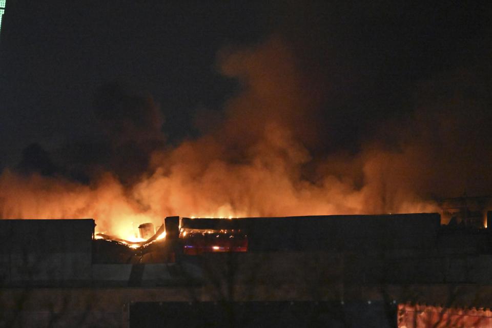 A massive blaze is seen over the Crocus City Hall on the western edge of Moscow, Russia, Friday, March 22, 2024. Several gunmen have burst into a big concert hall in Moscow and fired automatic weapons at the crowd, injuring an unspecified number of people and setting a massive blaze in an apparent terror attack days after President Vladimir Putin cemented his grip on the country in a highly orchestrated electoral landslide. (AP Photo/Dmitry Serebryakov)