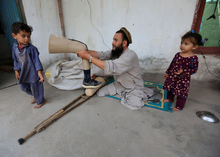 Khushhal Khan Ayobi 34, disable Afghan National Army (ANA) soldier fits his artificial limb at his house in Jalalabad province, Afghanistan. August 2, 2017. REUTERS/Parwiz