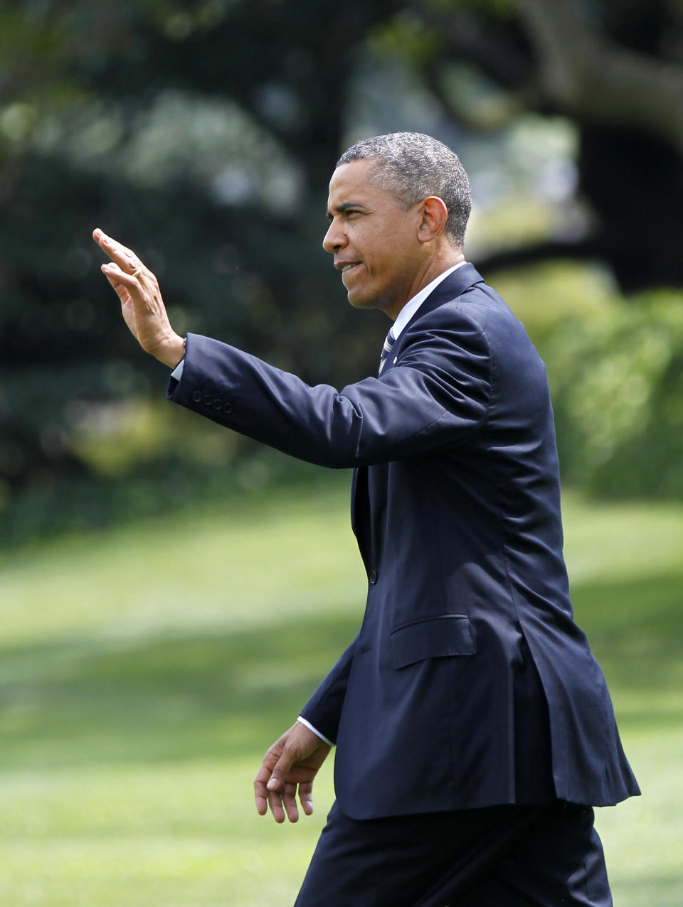 President Barack Obama waves as he walks across the South Lawn of the White House in Washington, Monday, Aug. 6, 2012. (AP Photo/Haraz N. Ghanbari)